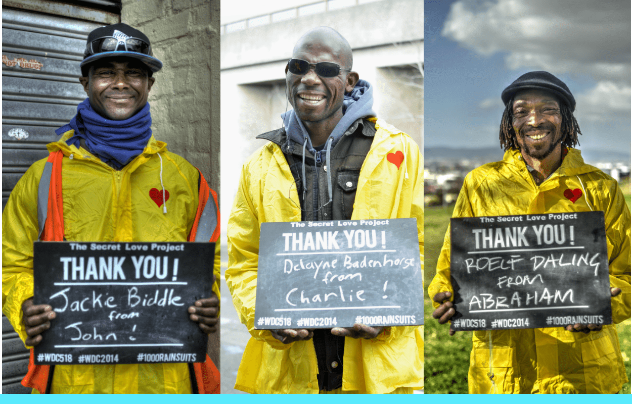 6 Homeless community members sharing thanks for receiving winter rain suits from the charity